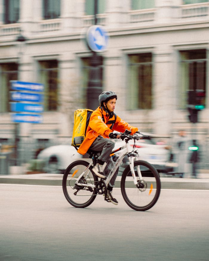 Young man delivering food on a bicycle in the streets of Madrid, Spain.