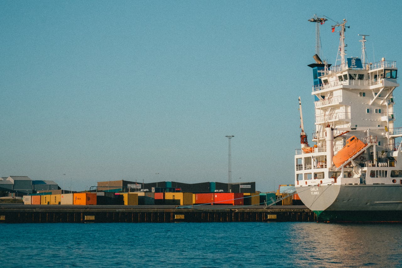 A large cargo ship at a harbor loaded with containers on a clear day.